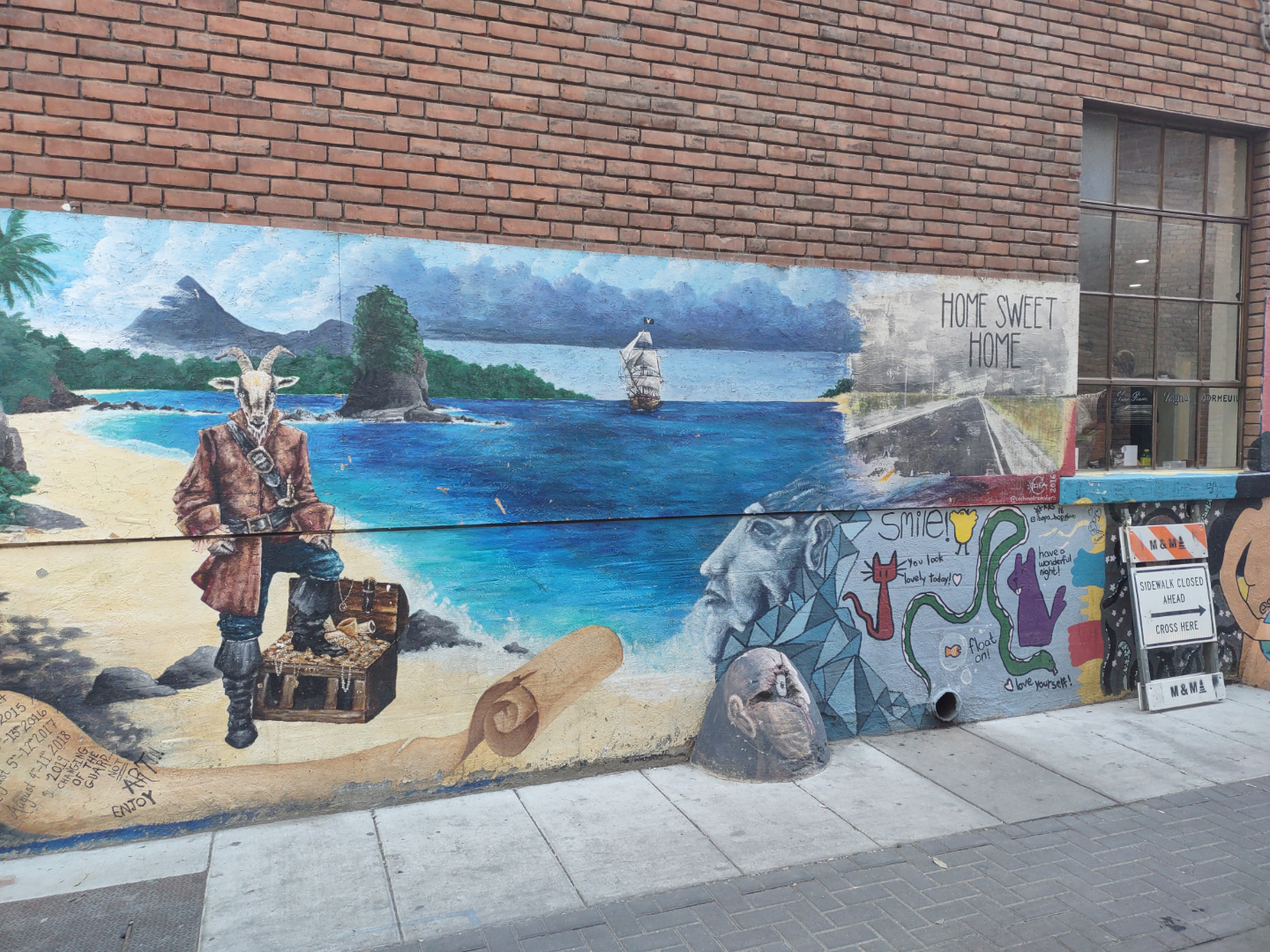 Mural on the Wall by Sidewalk